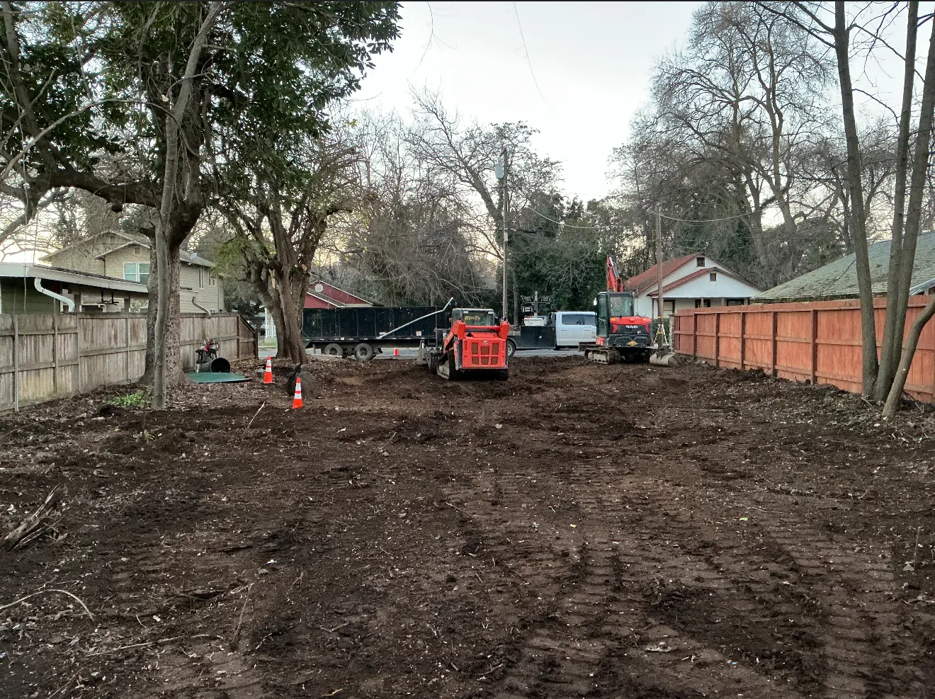 Cleared commercial lot with demolition equipment after teardown
