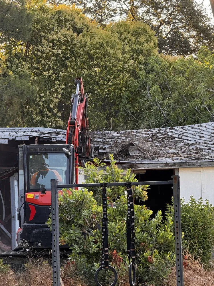 Demo Patrol excavator tearing down a double-wide mobile home