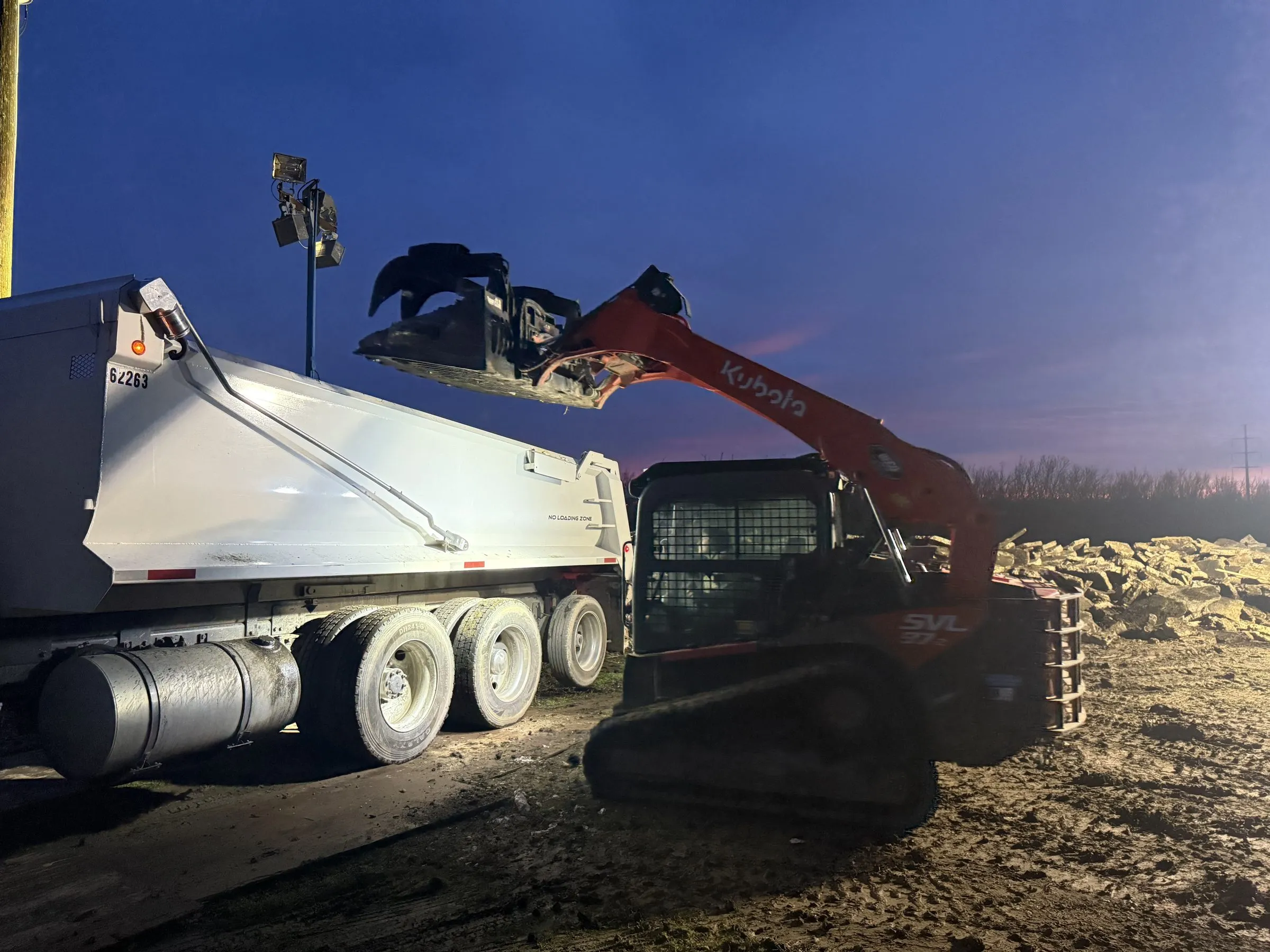 Demo Patrol crew loading a haul truck on a job site